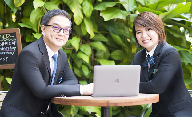 Francis and Ming of Ming Property posing with formal Propnex attire in cafe